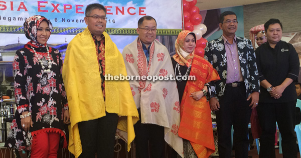 (From second left) Jahar, Long and Krtini show off  songket presented to them as memento. Also seen are Rita (left) and Hasan.