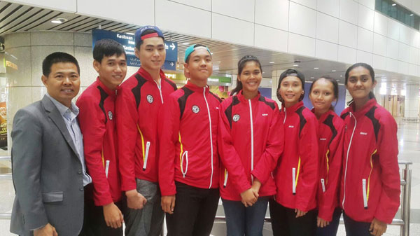 Some of Sarawak’s taekwondo exponents with team manager Tan Check Joon (left) and the coaches at the Kuching International Airport.