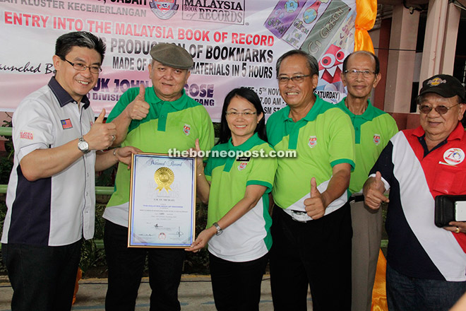 Jennifer receiving the Malaysia Book of Records certificate of acknowledgement from Christopher (left), witnessed by John (second left) and Philip (third right). 