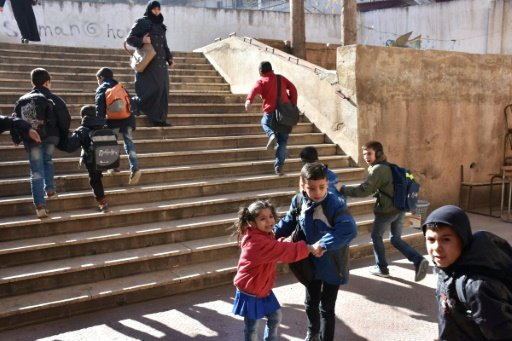 Syrian children cry and react after their school was reportedly hit by rebel rocket fire in the Furqan neighbourhood of the government-held side of west Aleppo, on November 20, 2016. - AFP File