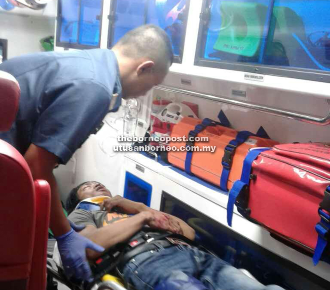 The 25-year-old motorcyclist being attended to by a Fire and Rescue Department (Bomba) personnel prior to being sent to hospital. 