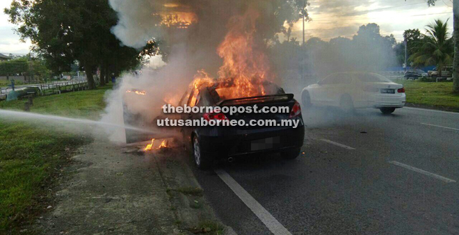 The car engulfed in flames.