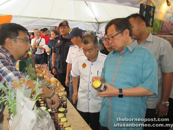 Abang Johari (right) together with Assistant Minister for Entrepreneur Development Naroden Majais on his right at one of the booths at Kuching Waterfront.