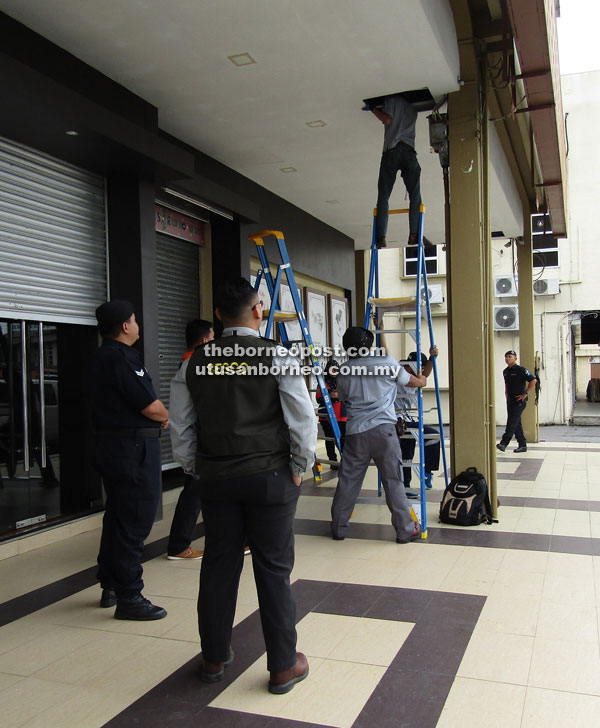 Sesco technicians locating the direct tapping cable hidden in the ceiling