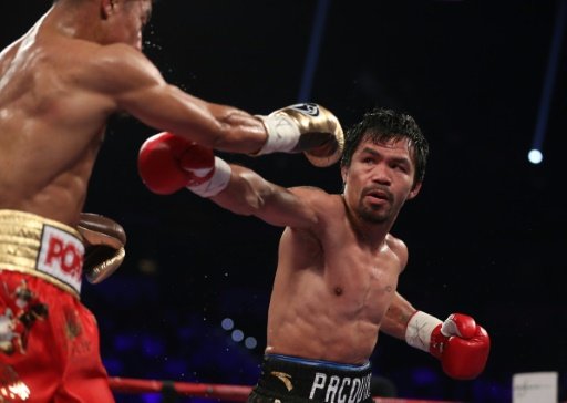 Manny Pacquiao (R) throws a right to the head of Jessie Vargas during their WBO welterweight championship fight, at the Thomas & Mack Center in Las Vegas, Nevada, on Nov 5, 2016. AFP Photo