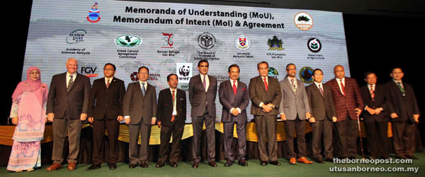 Musa (seventh right), Sam (sixth left), Lau (fourth left), Shahril (third right) and other signatories after the signing ceremony. - Photo by Aniq Azraei.