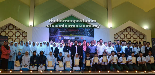 Winners and other contestants posing for a group photo with officials and invited guests.