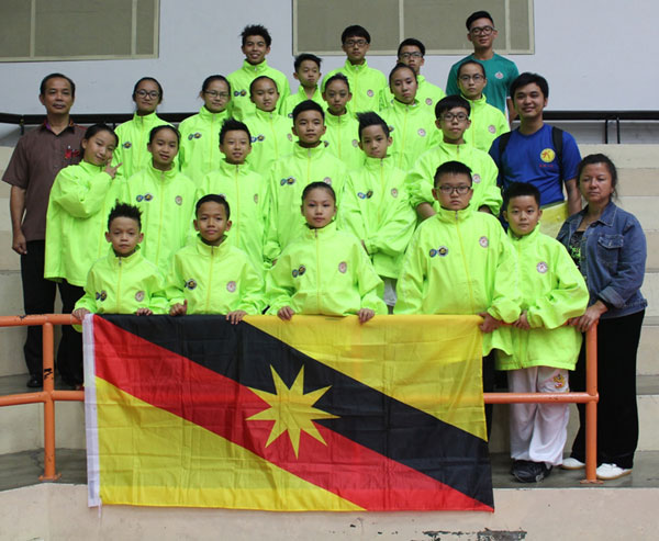 The Sarawak team and officials gather for a photograph at the end of the 6th Milo-KPM-WFM Wushu Championship at Han Chiang High School Indoor Stadium in Penang last Sunday.