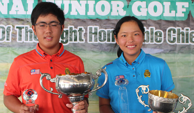 Lim Beng Keat of Kelab Golf Miri and Winnie Ng Yu Xuan of Malaysian Golf Association posing with their trophies after winning the boys’ and girls’ overall titles in the 18th Sarawak Chief Minister’s Cup International Junior Golf Championship at KGS yesterday 