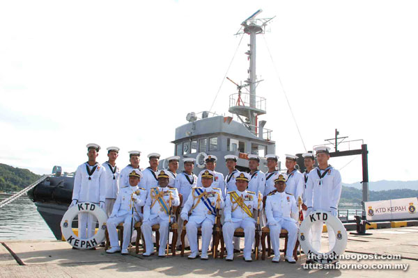 Kamarulzaman (seated centre) with Khairul Anuar (seated second right) and other officers posing for a photocall with crew of decommissioning of KTD Kepah.
