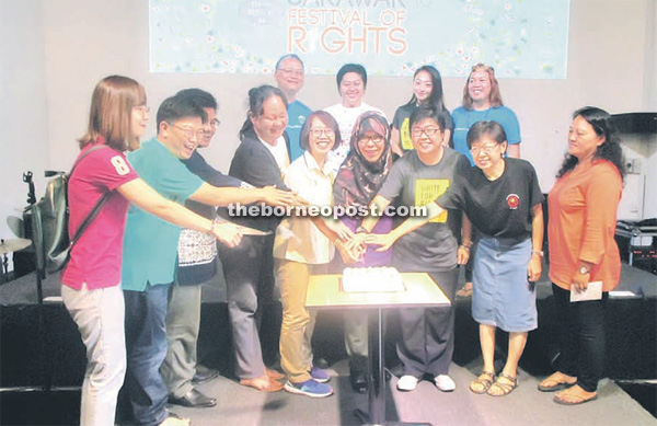 Suraya (front fourth right) joins the cake-cutting ceremony.