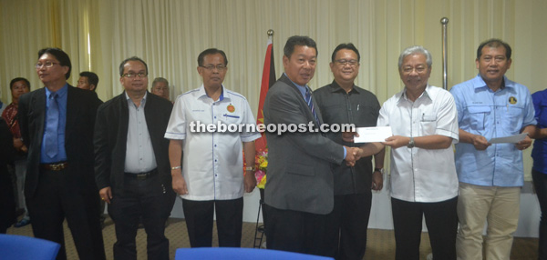 Baleh-Kapit Raft Safari Committee chairman Joseph Belayong receives the MRP grant from Masing (second from right). With them are (from left) Douglas, Elvis, Jamit, Nanta and Ugak 