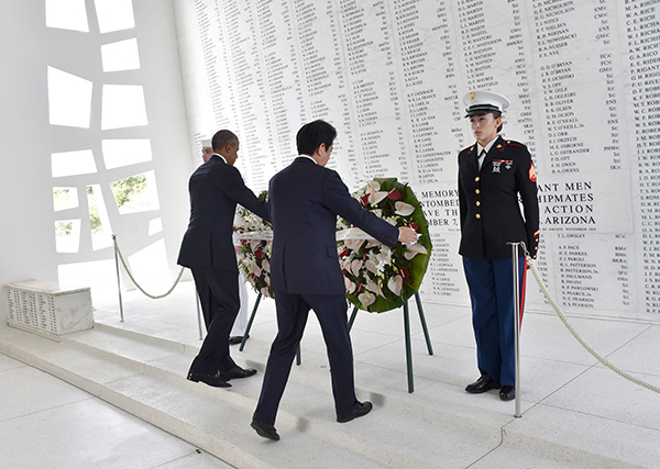 Obama (left) and Abe place wreaths at the USS Arizona Memorial at Pearl Harbor in Honolulu, Hawaii.  — AFP photo