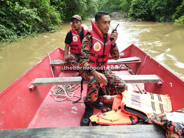 Azman (holding walkie talkie) and his man search for the missing Alexder.