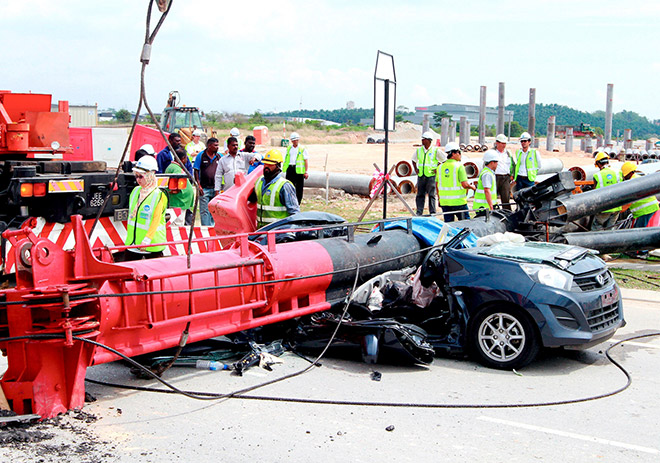 File photo shows construction workers lifting the piling machine that crashed a car killing a couple on Nov 5 in Klang. — Bernama photo