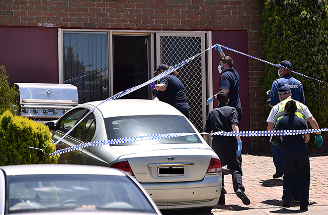 Police walk towards a door as they search a house in the Melbourne suburb of Meadow Heights, Australia during an operation regarding a plot to attack prominent sites in central Melbourne with a series of bombs on Christmas Day that authorities described as ‘an imminent terrorist event’ inspired by Islamic State. — Reuters photo