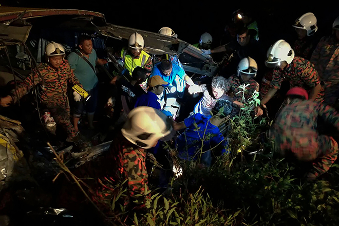Rescuers helping out a survivor. —  AFP photo