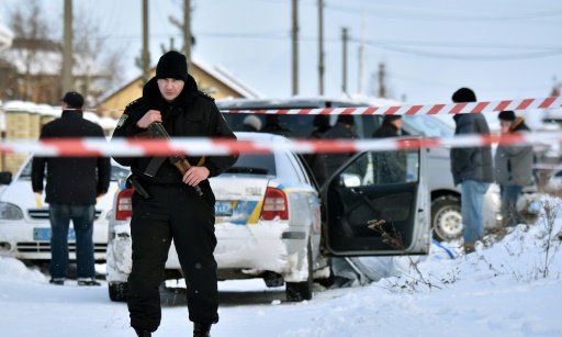 An armed policeman stands guard in the town of Knyazychy, about 30 kilometres east of Kiev, on December 4, 2016 -AFP photo