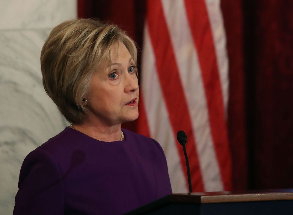 Former US Secretary of State Hillary Clinton speaks during a portrait unveiling ceremony for outgoing Senate Minority Leader Harry Reid (D-NV), on Capitol Hill December 8, 2016, a speech during which she warned against the perils of fake news. AFP Photo