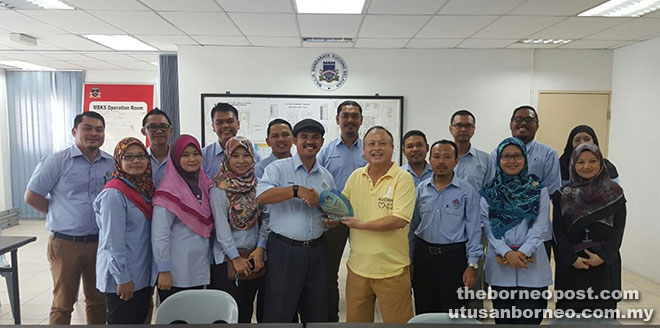 Chan (front row, fourth right) receives a souvenir from Miskon as the delegates from Kuala Langat Municipal Council and MBKS staff look on.