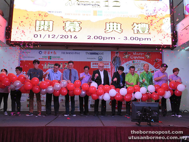 Yii with the committee members and invited guests bursting  balloons to mark the opening of Mitraf 12. 