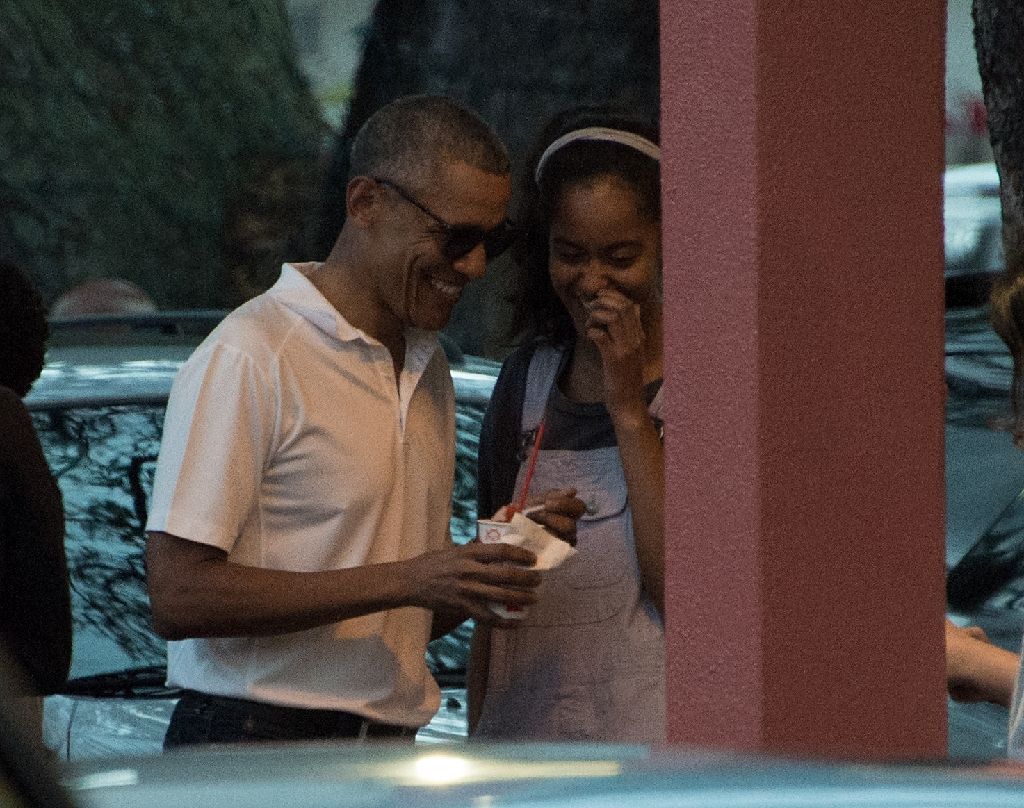 US President Barack Obama enjoys shave ice with his daughter Malia and friends at the Island Snow parlor in Kailua, Hawaii, on Dec 24, 2016. AFP Photo