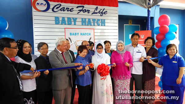 Fatimah (centre) cuts the ribbon to launch the KPJ Baby Hatch. Also seen from fourth left are Dr Ling, Mah, Hasidah and Dr Rahman.