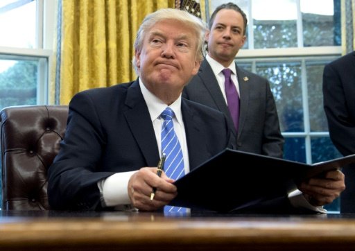 Juliette MICHEL | US President Donald Trump signs an executive order on January 23, 2017, to withdraw from the Trans-Pacific Partnership trade deal -AFP photo