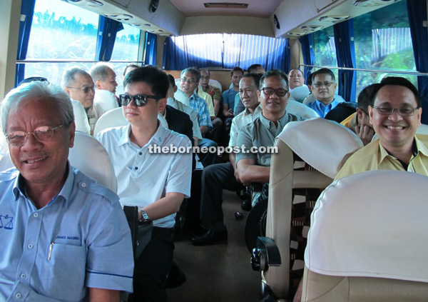 Masing (left), Parti Rakyat Sarawak assemblymen and his officers on the bus trip to survey the coastal road.