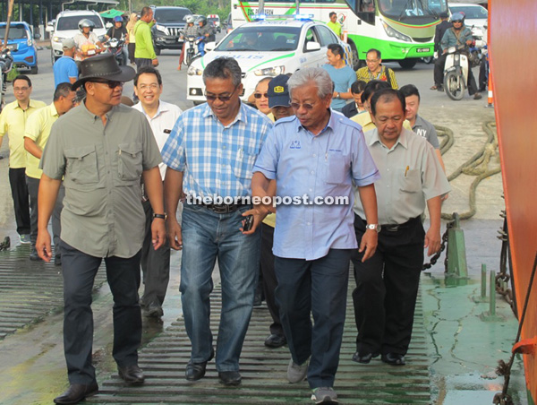 (From left) River Transportation and Safety Assistant Minister Liwan Lagang, Pelagus assemblyman Wilson Nyabong and Masing walking up the ramp onto the Muara Tuang ferry.