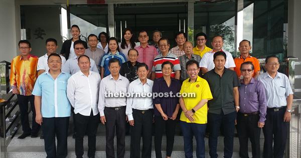 Tan (fourth left) together with Lee (fifth left), Sim (sixth left) and representatives from each of the welfare organisations at the entrance of the Lee Onn Construction Company office yesterday.