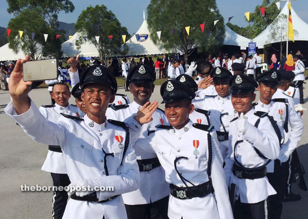 Newly-graduated constables take a group selfie to commemorate the end of their training.