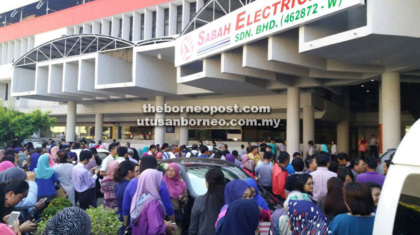 Sabah Electrical Sdn Bhd staff and members of the public gathered outside the building after it was evacuated due to the tremors.