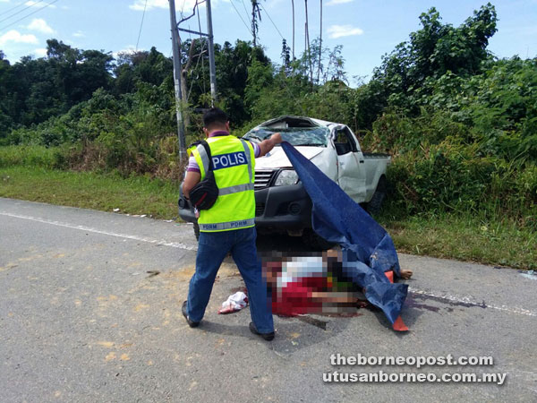 Police personnel covers Imat’s body at the scene of the crash.