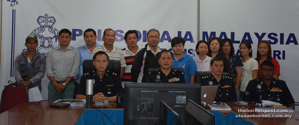 Ang (seated, second left) in a group photo with second-hand dealers in Miri after the briefing at police headquarters.