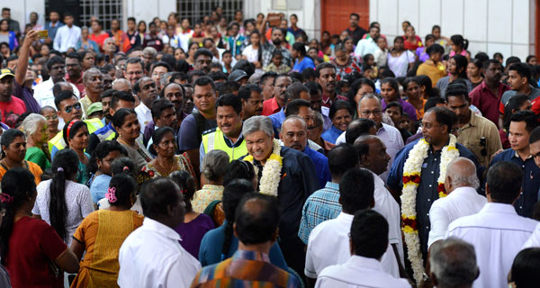 Ahmad Zahid (centre, garlanded) being greeted upon arrival at Dewan India Sanmarka — Bernama photo