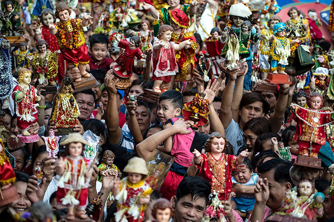 STO NINO FESTIVAL: Residents carry religious icons of the baby Jesus during the annual Sto Nino (baby Jesus) feast in Manila. The Philippines is Asia’s bastion of Catholicism and the Sto Nino feast is one amongst dozens of religious festivals honouring various saints and religious icons, a legacy of three centuries of Spanish rule across the archipelago. — AFP photo