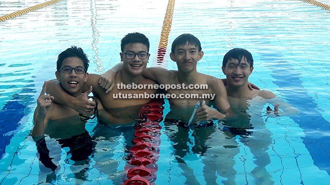 Zachary Tan (second left), Hii Puong Wei (second right), Joash Voon (left) and Hii Puong Hou cooling down at the pool yesterday.