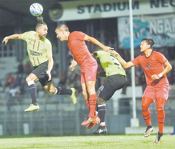 Sarawak and Sabah players in action during the friendly match on Sunday night.