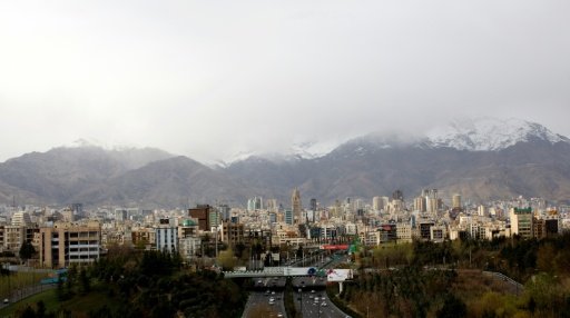 The 15-storey Plasco building in Tehran, Iran's first high-rise, has collapsed live on TV after a fire engulfed its top floors - AFP