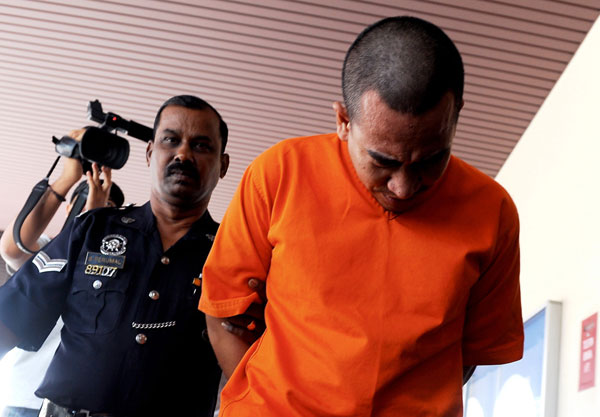 Jaafar being escorted out of the court. — Bernama photo