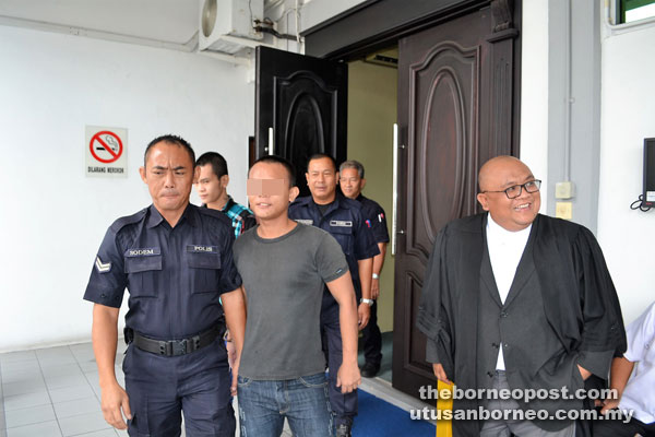 The two accused persons being led out of the court room after sentencing.