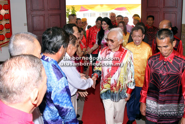 Taib greeting SUPP members upon his arrival at the party’s headquarters on the first day of the Chinese New Year celebration on Saturday. Dr Sim is at second right. 