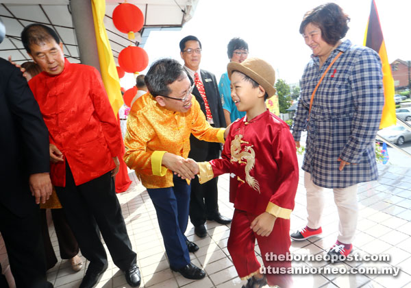 Dr Sim welcoming a boy to the SUPP open house.