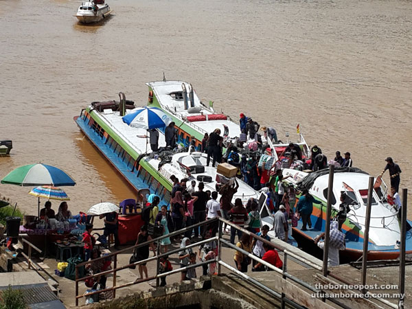 Wharf workers help passengers load their goods on board the express boats. 