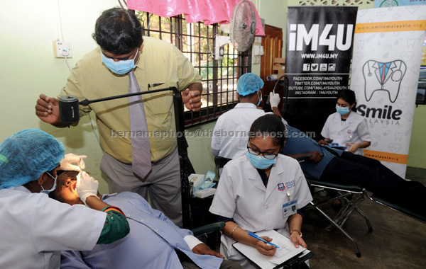 Smile Malaysia volunteers provide free medical and dental screening for the underprivileged community in Kampung Perlis. — Bernama photo