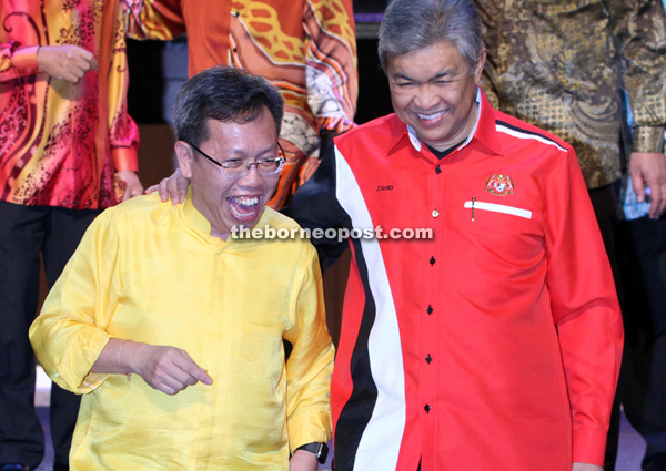 Ahmad Zahid and Dr Sim (left) walk down the stage together after the tossing of the ‘yee sang’.