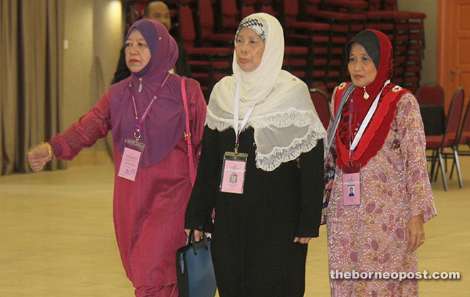 Jamilah (centre), flanked by her proposer and seconder, enters the nomination centre. – Photo by Chimon Upon
