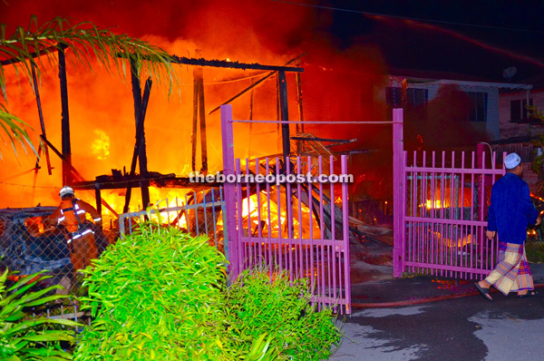 The fire at its height as it sweeps through five wooden houses in Kampung Bahagia. 