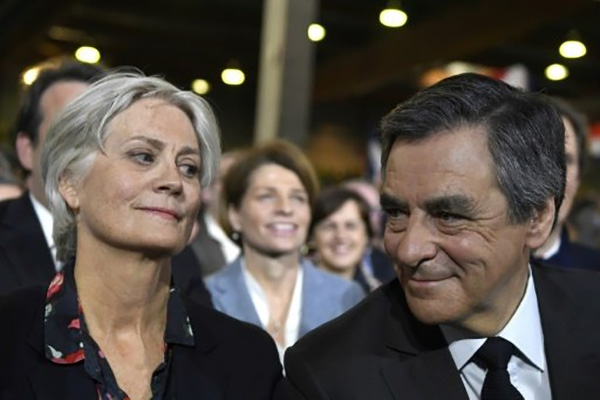 © AFP/File | French presidential candidate Francois Fillon pictured with his wife Penelope on January 29, 2017 